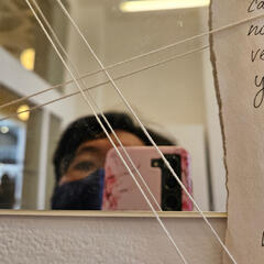 Photo of me taking a picture in front of the mirror at Pacific Northwest College of Arts during an art exhibition.